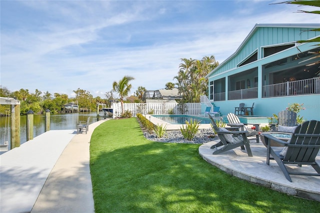 view of yard with a water view and a boat dock