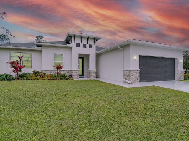 view of front facade featuring a garage and a lawn