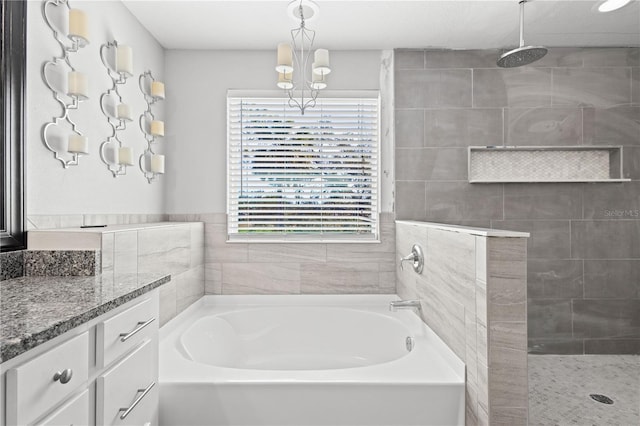 bathroom with vanity and separate shower and tub