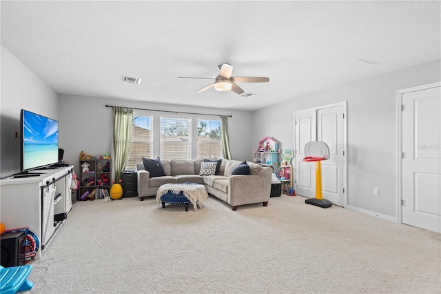 carpeted living room featuring a textured ceiling and ceiling fan