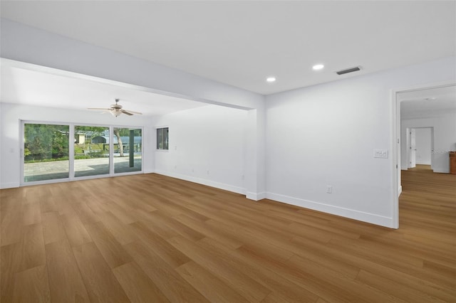 unfurnished room with ceiling fan and light wood-type flooring