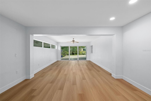 empty room with ceiling fan and light hardwood / wood-style floors