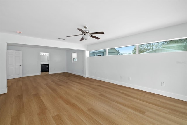 empty room with light hardwood / wood-style floors and ceiling fan