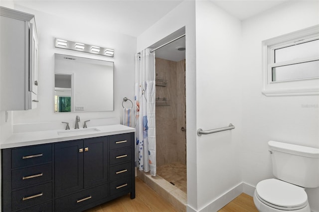 bathroom with vanity, hardwood / wood-style floors, toilet, and a shower with shower curtain