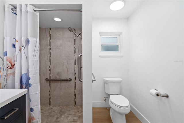 bathroom featuring walk in shower, vanity, toilet, and hardwood / wood-style floors