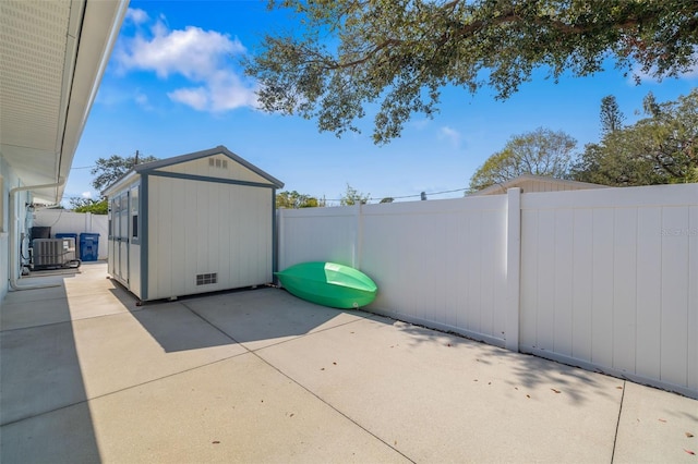 view of patio / terrace with central AC and a storage unit