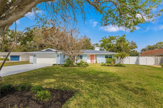 ranch-style home featuring a garage and a front lawn