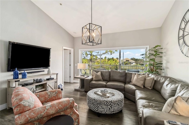 living room with high vaulted ceiling, an inviting chandelier, and dark hardwood / wood-style flooring