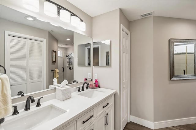 bathroom featuring vanity and tiled shower