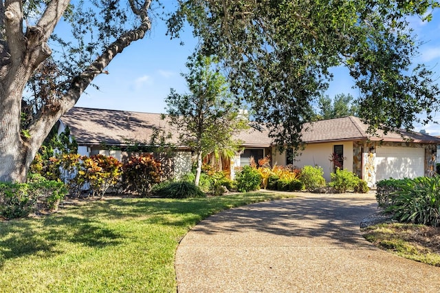 ranch-style home featuring a garage and a front yard