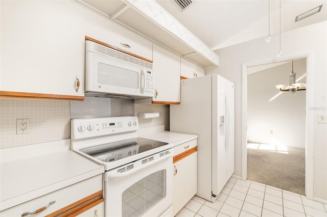 kitchen with light tile patterned floors, white appliances, white cabinetry, an inviting chandelier, and decorative backsplash