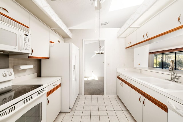 kitchen with sink, white cabinetry, pendant lighting, white appliances, and backsplash