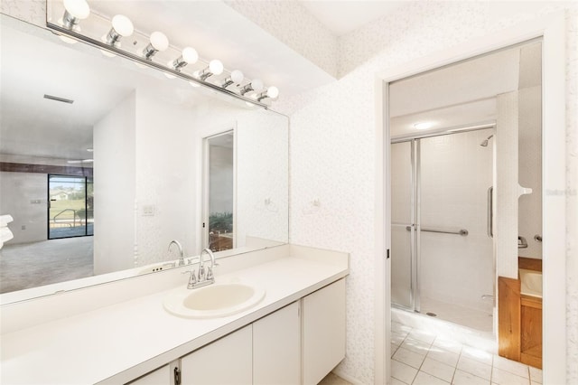 bathroom featuring vanity, tile patterned floors, and a shower with shower door