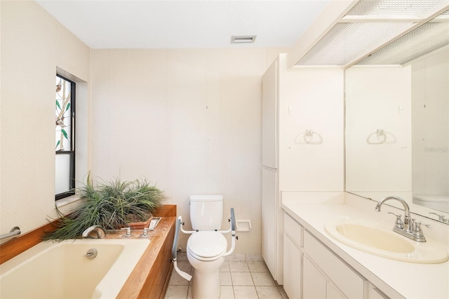 bathroom with vanity, a tub to relax in, tile patterned floors, and toilet