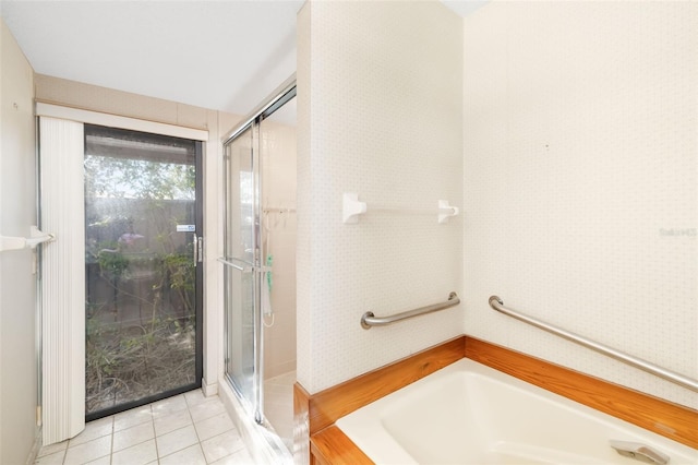 bathroom with separate shower and tub and tile patterned flooring