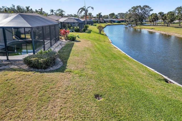 view of yard featuring glass enclosure and a water view