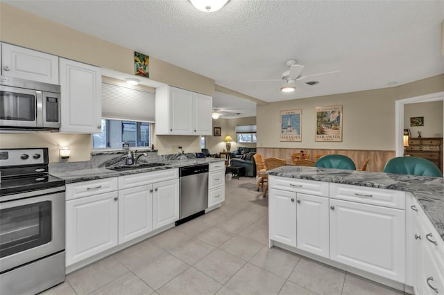 kitchen featuring appliances with stainless steel finishes, sink, and white cabinets