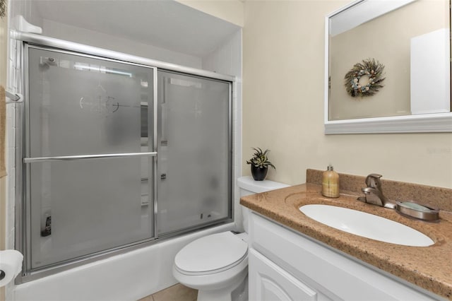 full bathroom featuring vanity, tile patterned floors, enclosed tub / shower combo, and toilet