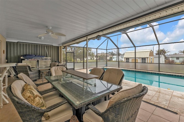 view of patio / terrace with a lanai, ceiling fan, and a pool with hot tub