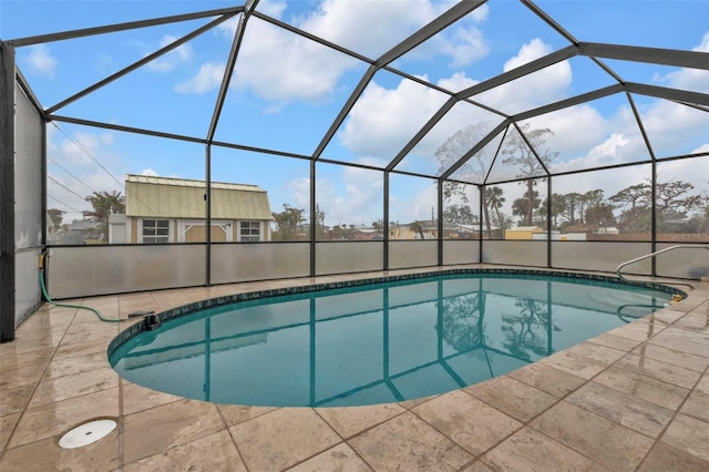 view of pool featuring a patio area and glass enclosure