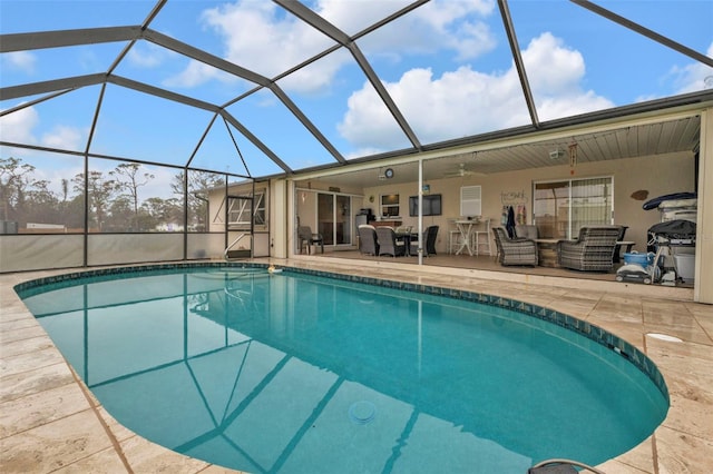 view of swimming pool featuring an outdoor living space, ceiling fan, glass enclosure, and a patio area