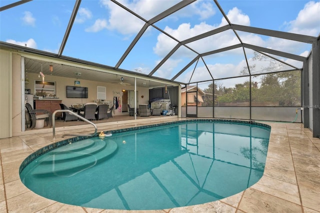 view of pool with ceiling fan, an outdoor living space, a patio, and glass enclosure