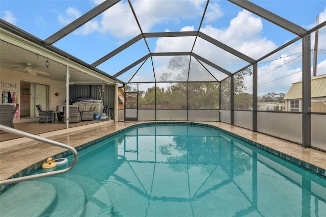 view of pool with ceiling fan, an outdoor living space, a lanai, and a patio area