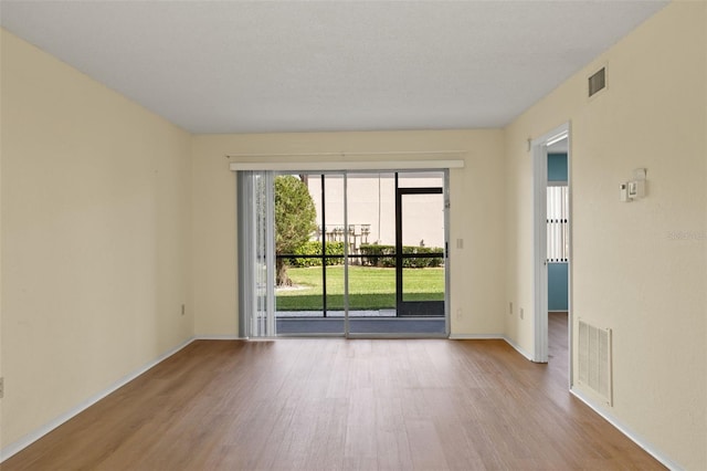 unfurnished room with light hardwood / wood-style flooring