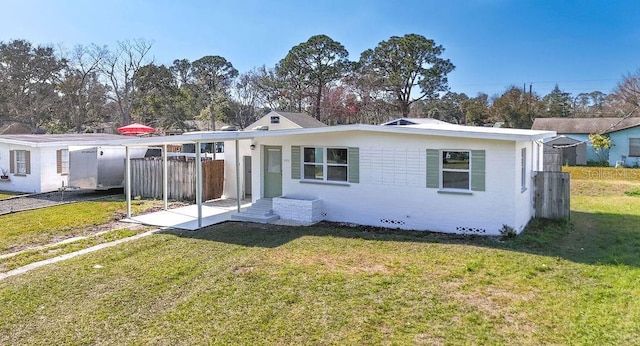 rear view of house featuring a yard