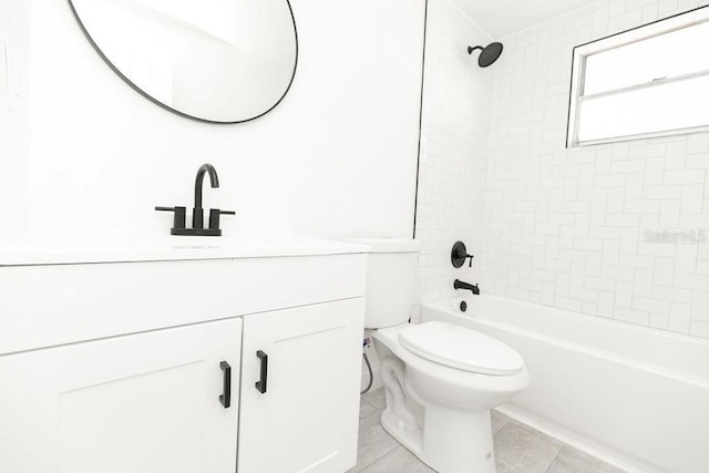 full bathroom featuring vanity, tile patterned flooring, tiled shower / bath combo, and toilet