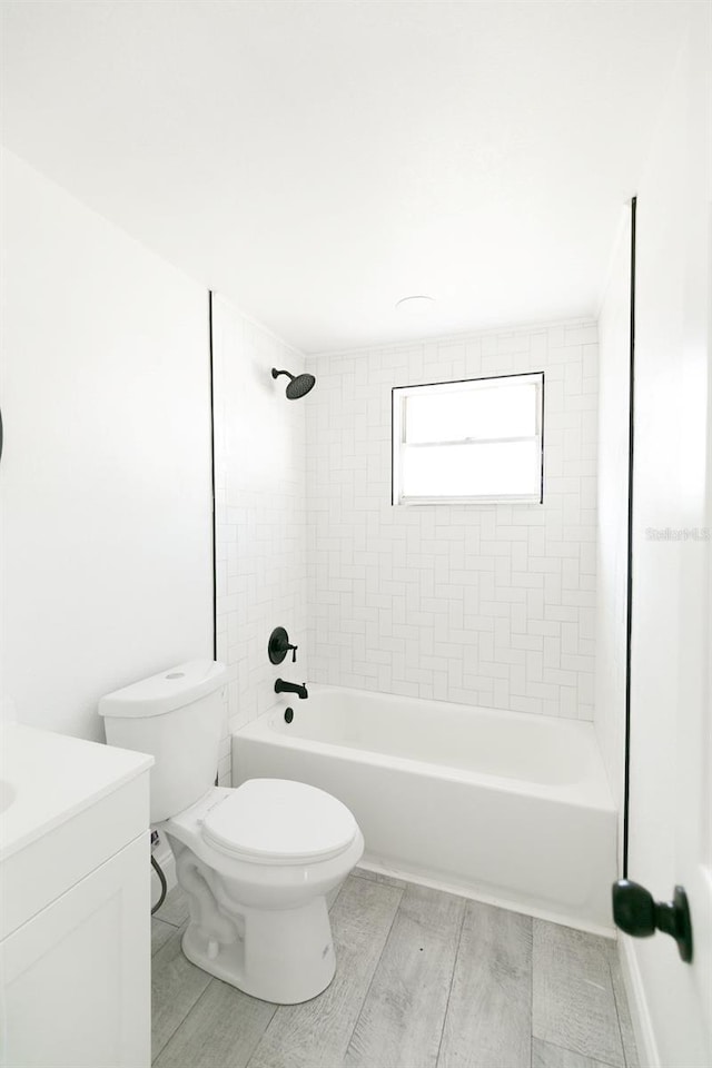 full bathroom featuring vanity, toilet, and tiled shower / bath combo