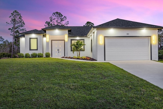 view of front facade featuring a yard and a garage