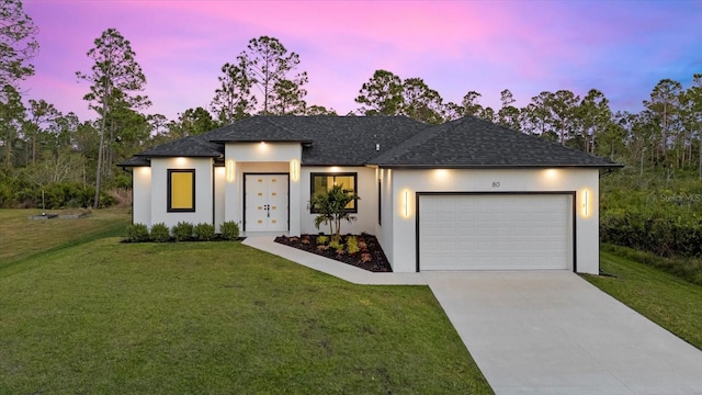 view of front facade featuring a yard and a garage