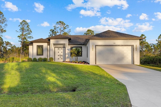 view of front of property featuring a garage and a front yard