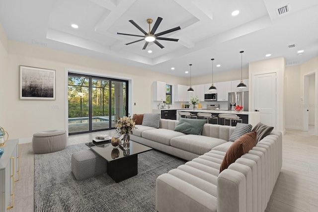 living room featuring coffered ceiling and ceiling fan