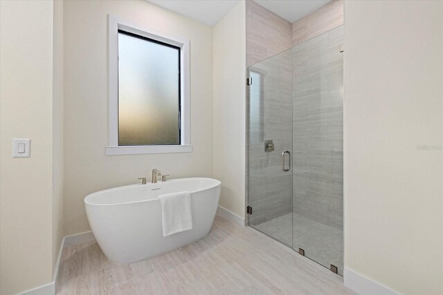 bathroom with shower with separate bathtub