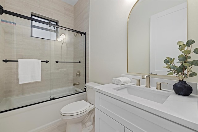 full bathroom with vanity, combined bath / shower with glass door, and toilet