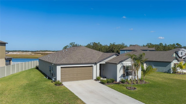 ranch-style home with a water view, a garage, and a front yard