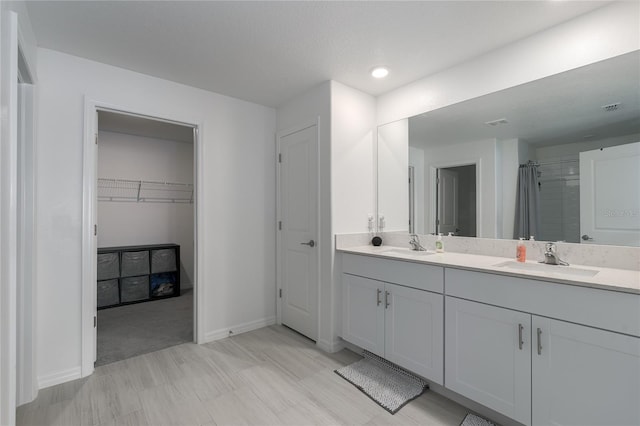 bathroom with vanity and a shower with shower curtain