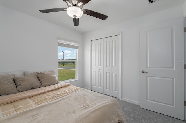 bedroom featuring carpet, ceiling fan, and a closet