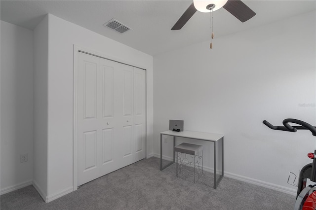 interior space featuring ceiling fan and a closet