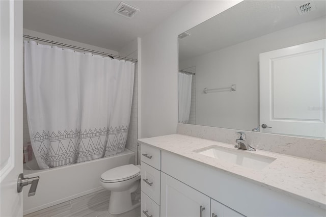 full bathroom with shower / tub combo with curtain, vanity, and toilet