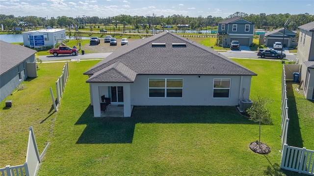 back of house featuring a water view, central AC, and a patio area