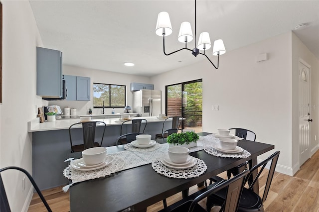 dining area featuring sink, plenty of natural light, and light hardwood / wood-style floors