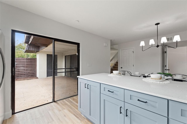 kitchen with pendant lighting and light hardwood / wood-style flooring