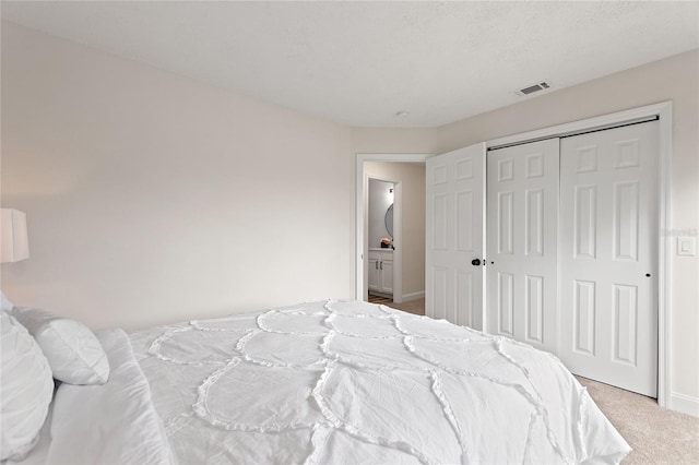 carpeted bedroom featuring a closet