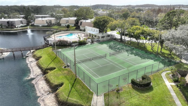 view of sport court with a water view