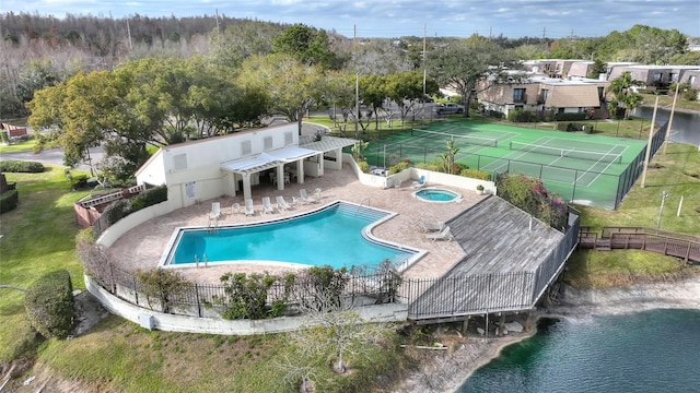 view of pool with a patio area, a community hot tub, and a water view