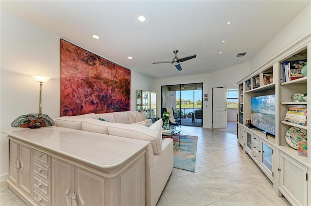 tiled living room featuring ceiling fan