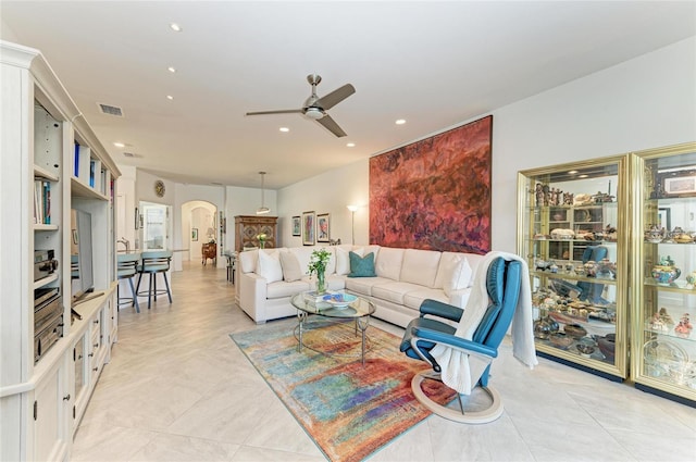 tiled living room with ceiling fan